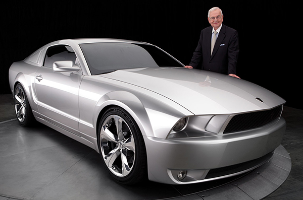 Lee Lacocca posing with the 2009 Ford Mustang