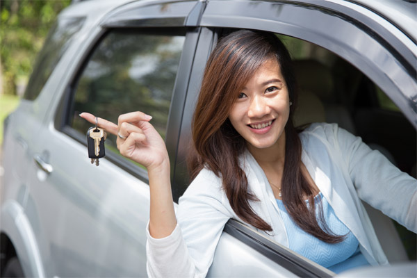 Woman holding electric car keys
