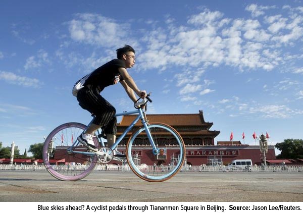 Blue skies ahead? A cyclist pedals through Tiananmen Squar in Beijing